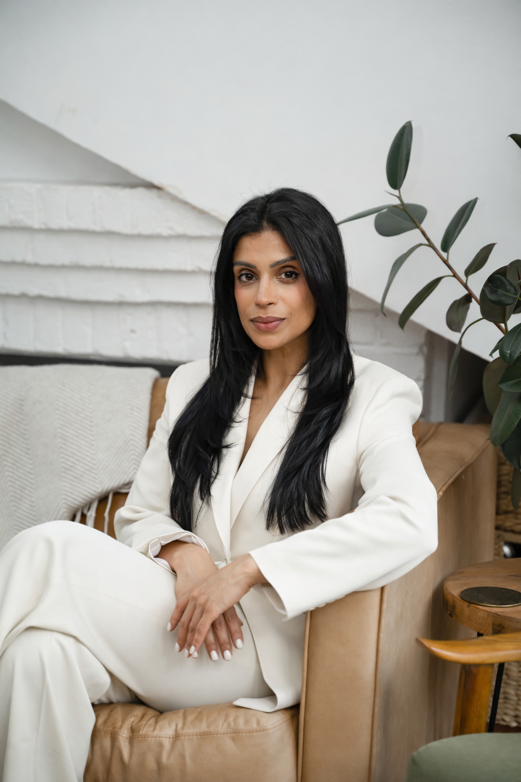 dr saema tahir sitting in a chair