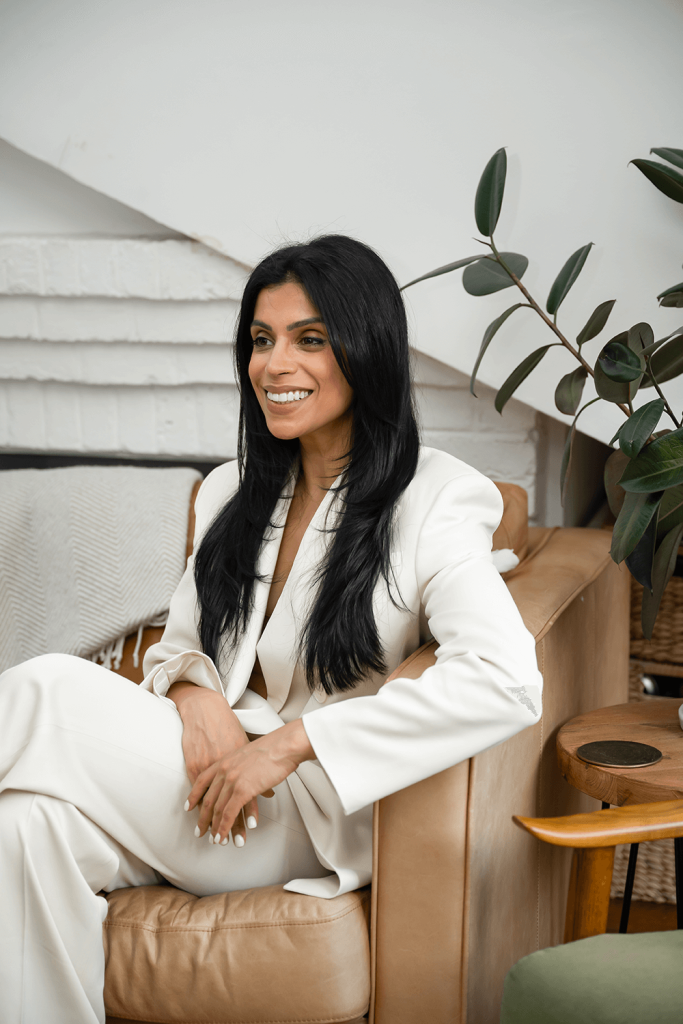 Dr. Saema Tahir, M.D. sitting in chair telling her bio